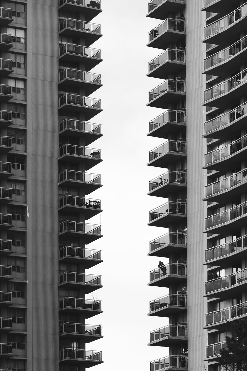 the terraces of two council blocks cut shapes in the grey sky