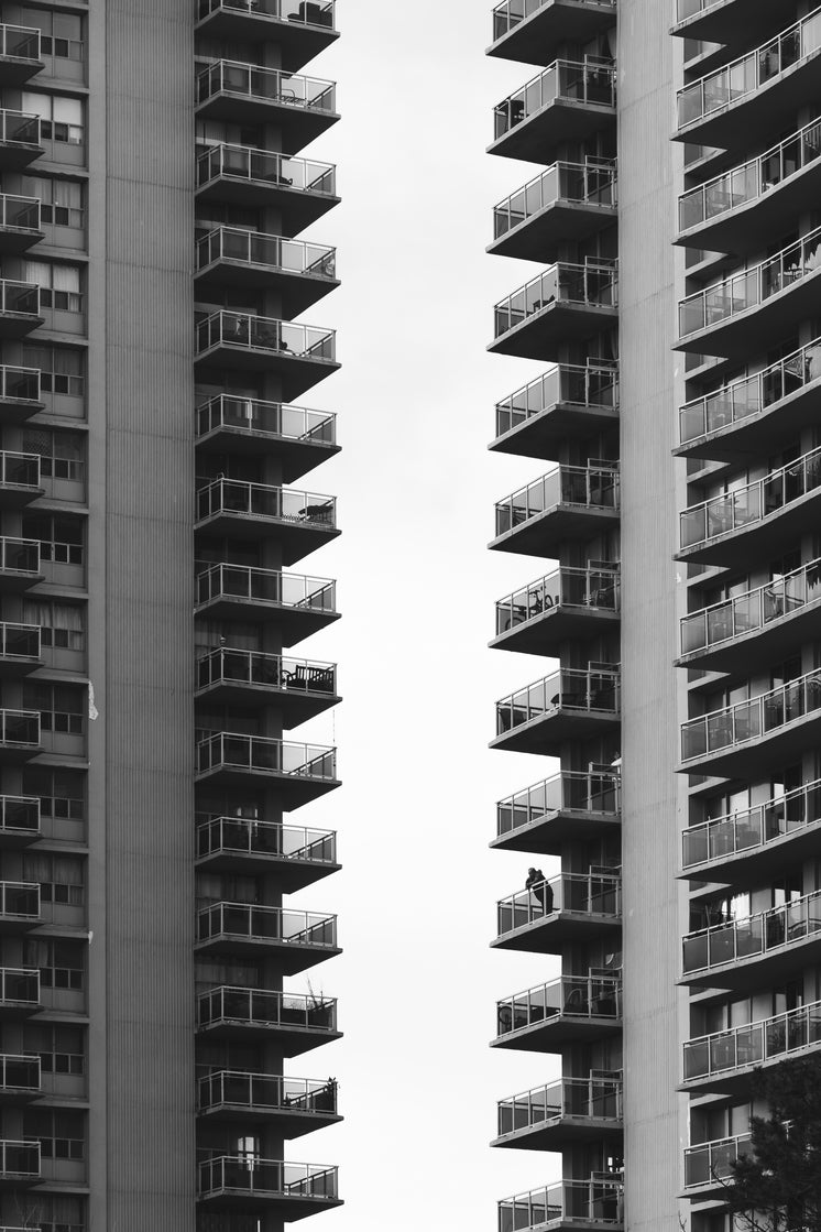 The Terraces Of Two Council Blocks Cut Shapes In the Grey Sky