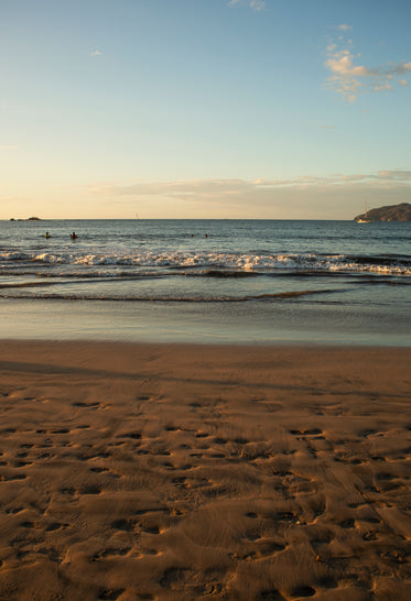 the tide rolls in on a sunny beach scene