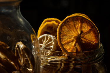 the top of a glass jar filled with dried lemon slices