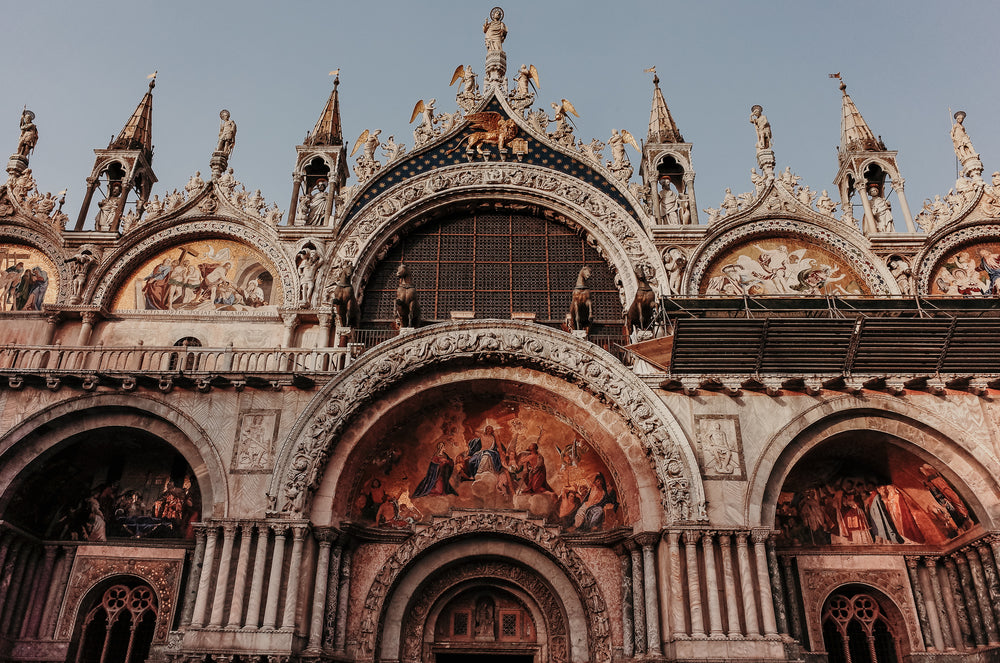 the top of a religious building with sculptures