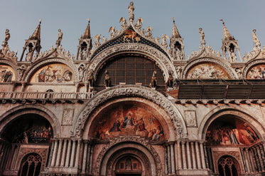 the top of a religious building with sculptures