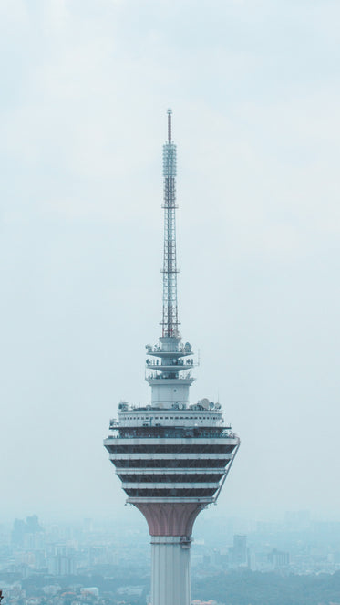 the top of a skyscraper that sits above a city