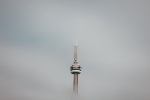 the toronto tower floats in the clouds