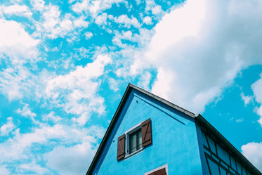 the wooden gables of blue house under a blue sky