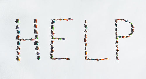 the word help spelled out with plastic miniatures
