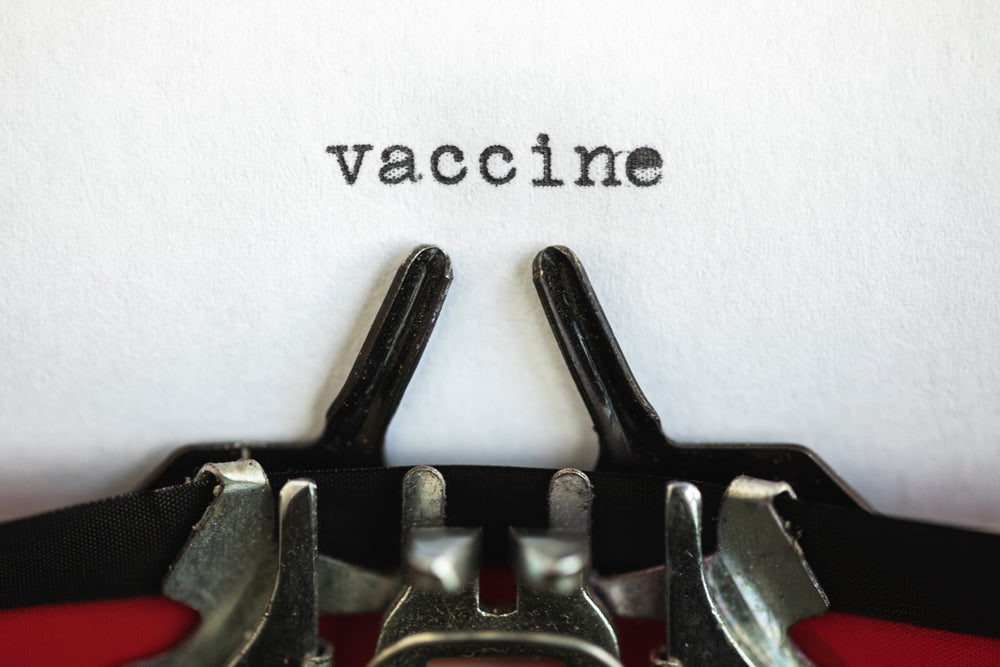 the words vaccine on a typewriter