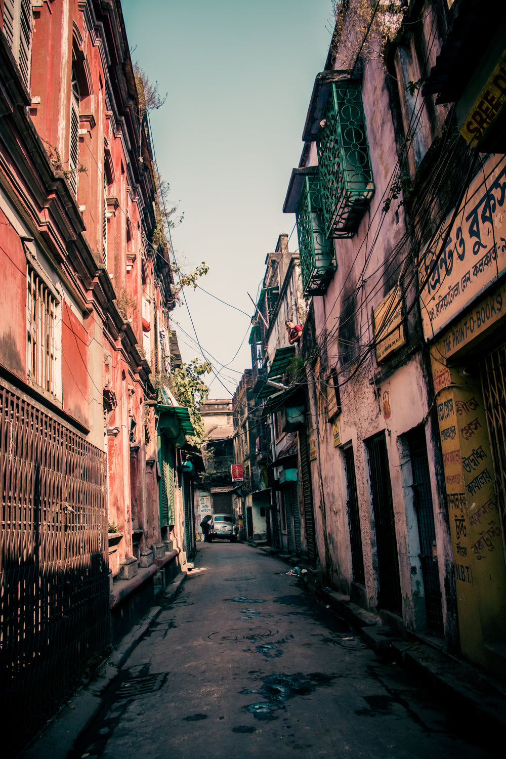 thin rustic alleyway with buildings each side