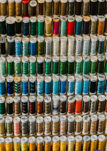 thread spools stacked on a shelf