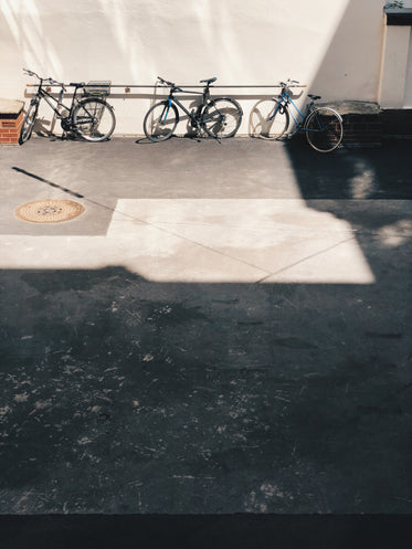 three bikes leaning on a wall