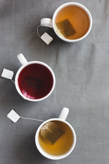 three cups of tea steeping