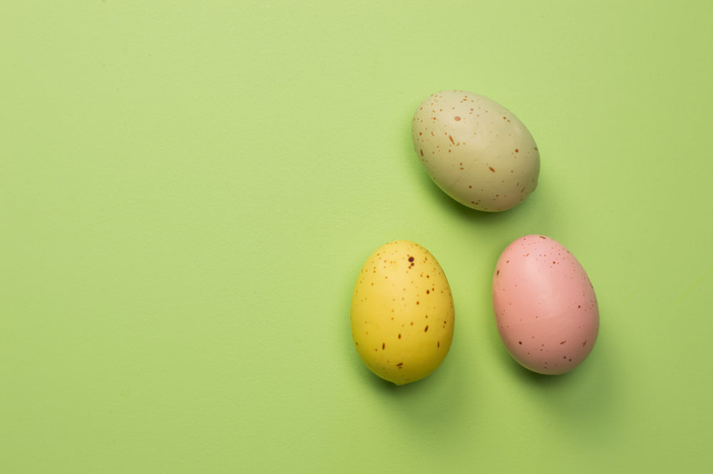 three easter eggs on green background