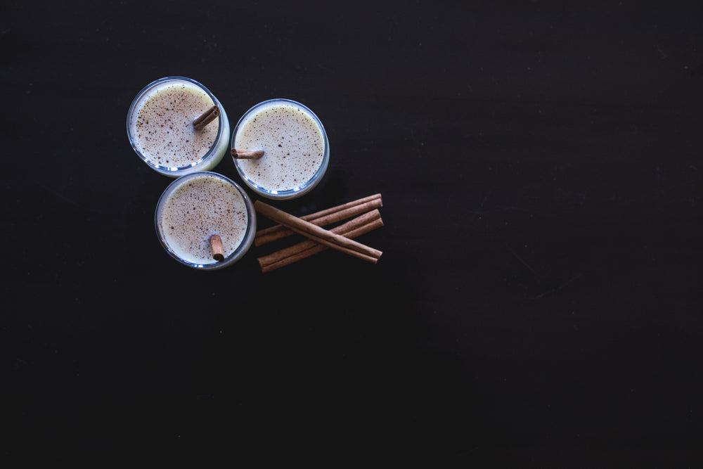 three egg nogs and some cinnamon sticks