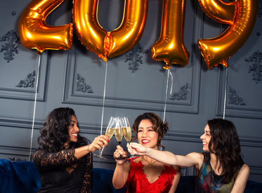 three friends celebrate with a champagne toast