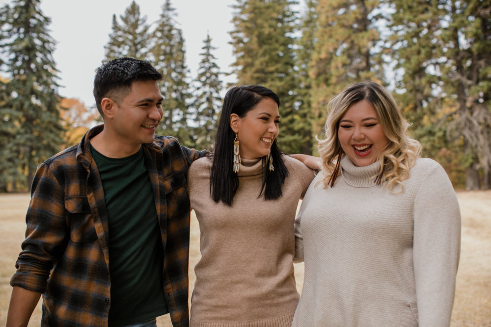 three friends share a laugh on fall afternoon