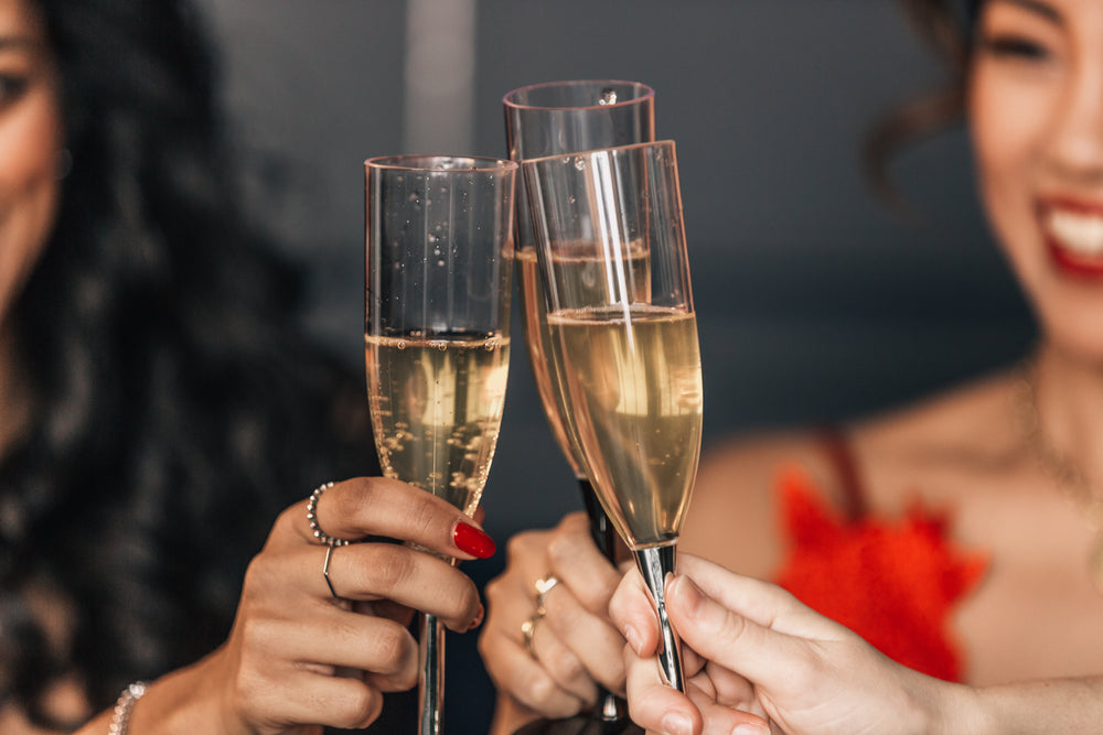 three friends toasting with champagne