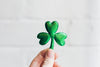 three leaf clover held in hand