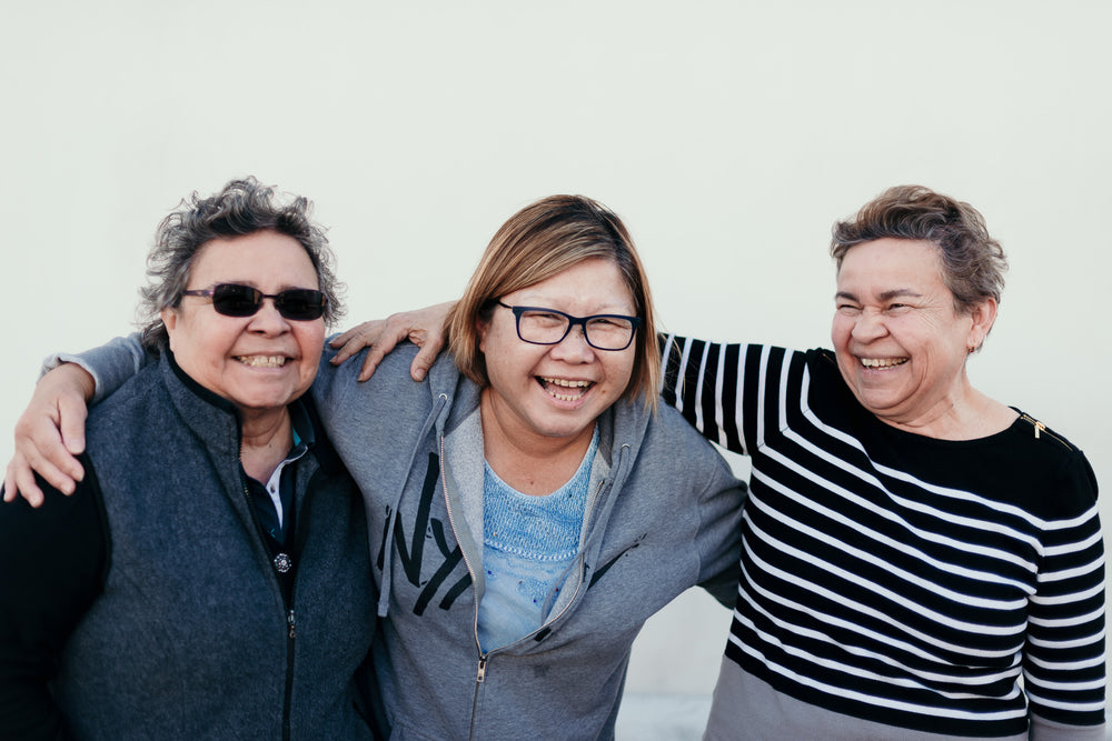 three mature women laugh in friendship