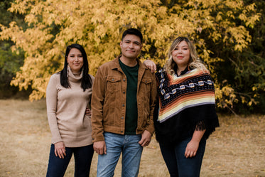 three people outside posing for the camera