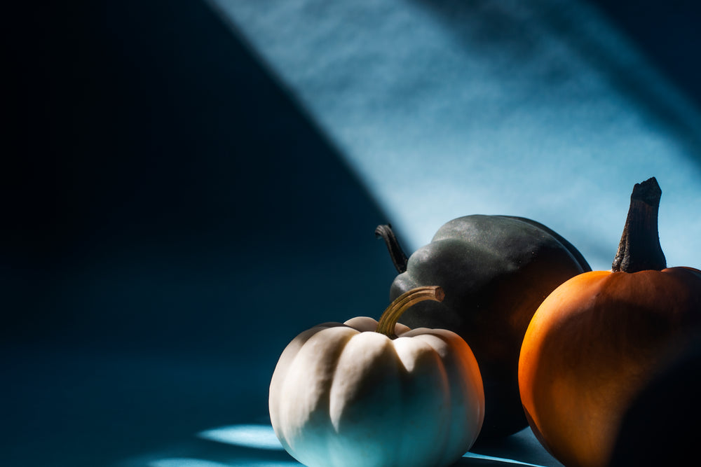 three pumpkins in a beam of sunlight