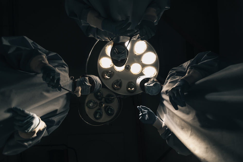 three surgeons stare down during surgery