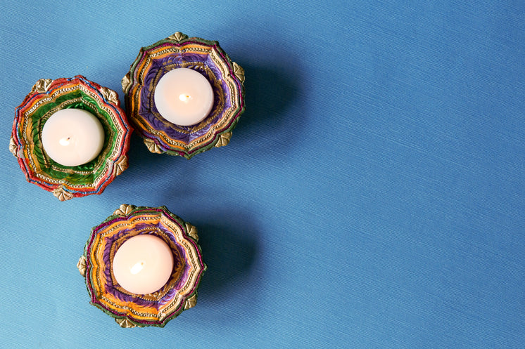 three-tealights-in-diya-on-blue-tabletop.jpg?width=746&format=pjpg&exif=0&iptc=0