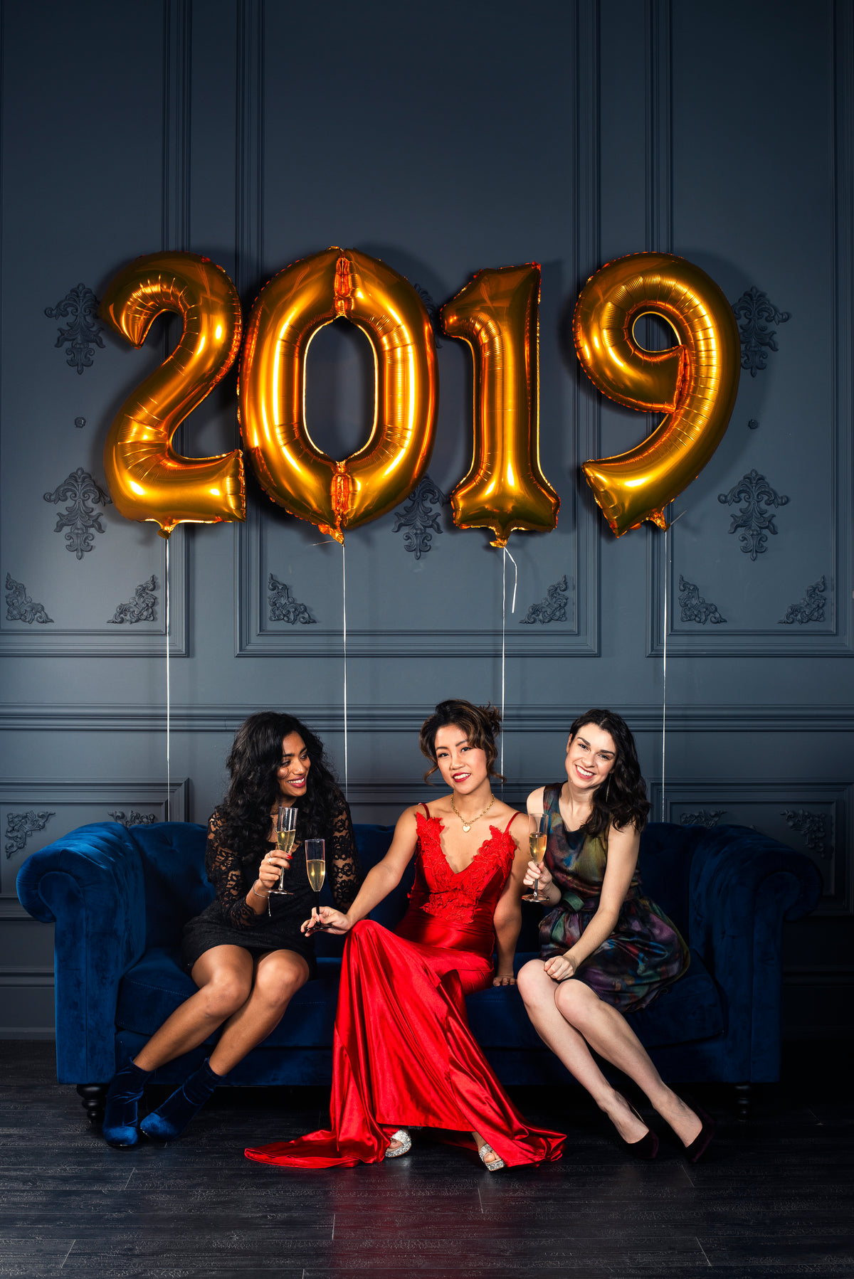 three woman strike a new year's pose