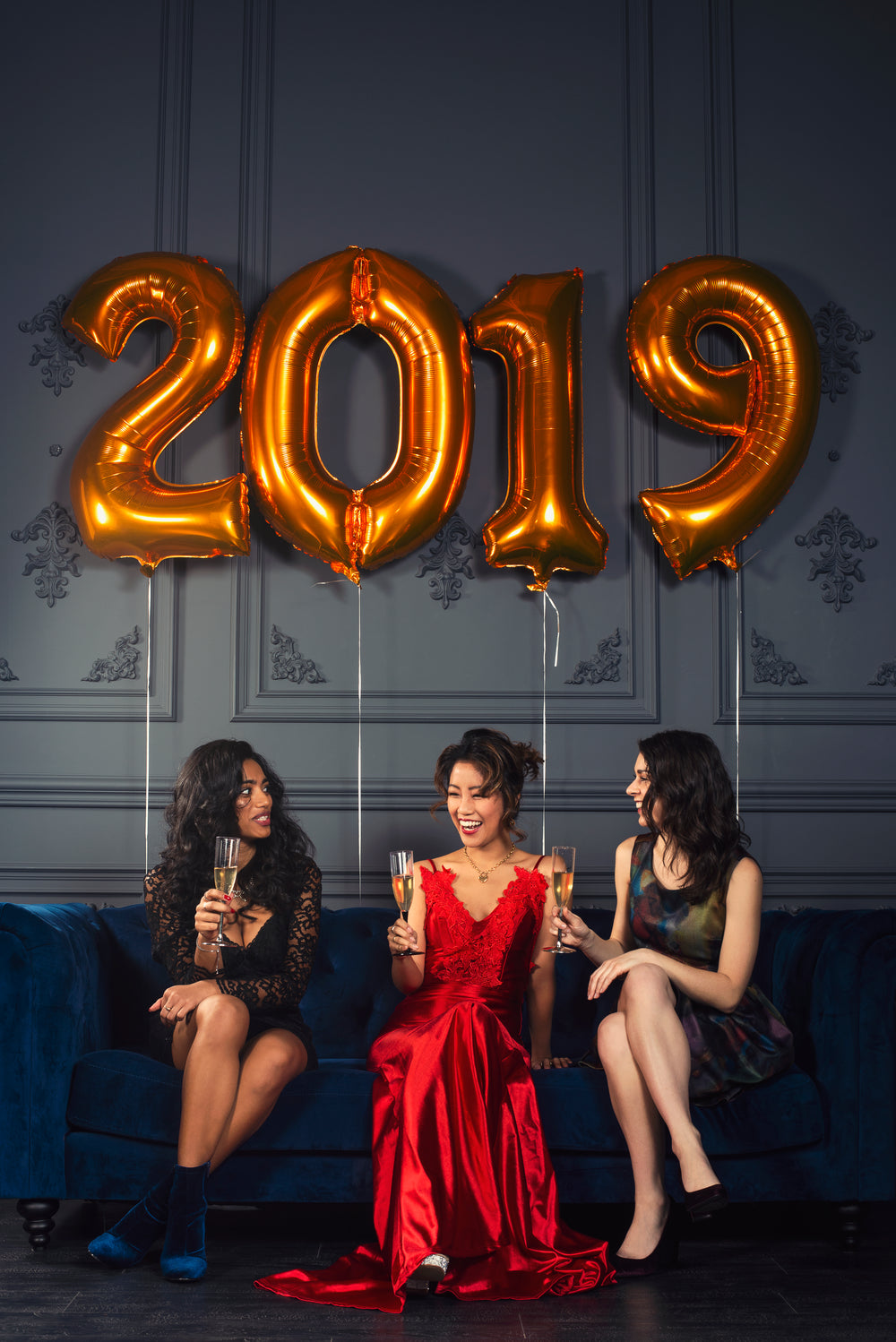 three women laughing at new year's eve party