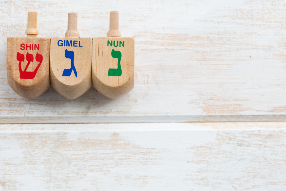 three wooden dreidel