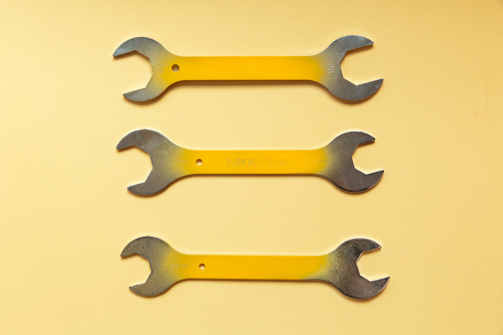 three yellow painted wrenches