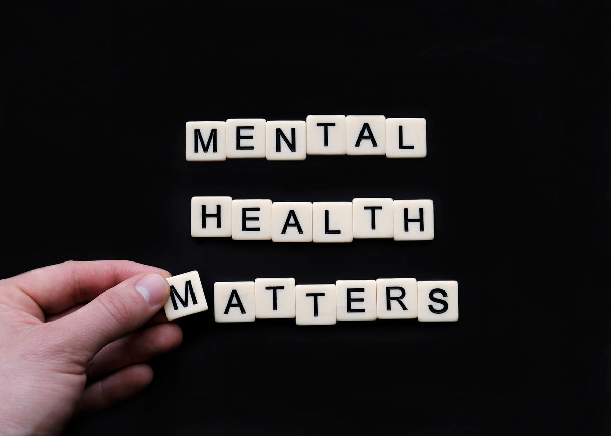 tiles lay on a black surface reading mental health matters
