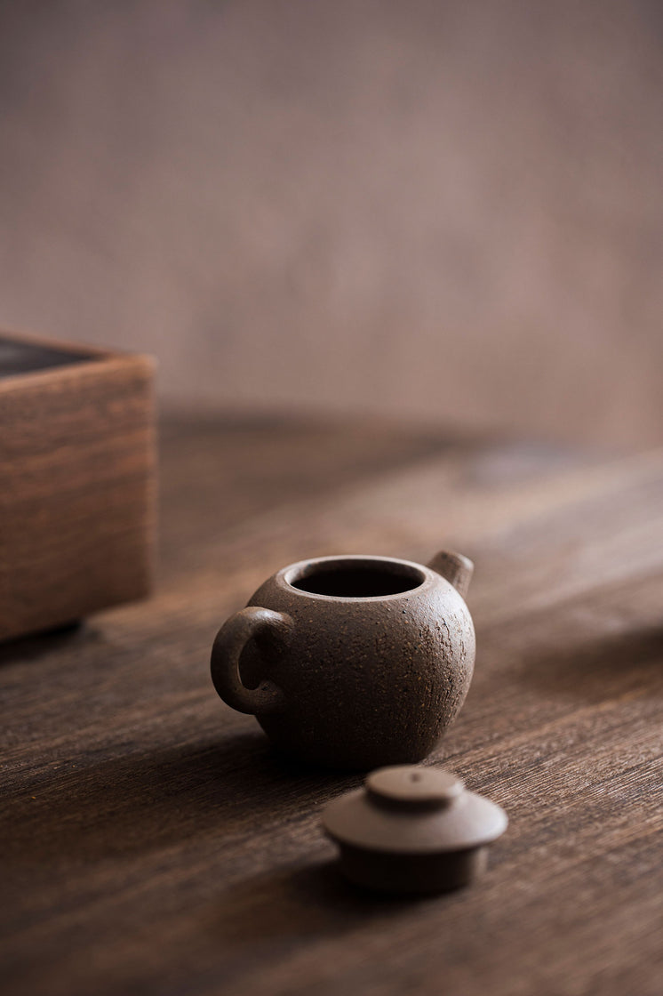 Tiny Teapot Sits With The Lid Off On A Wooden Table