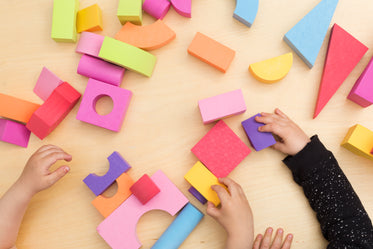 toddler hands playing with colorful blocks