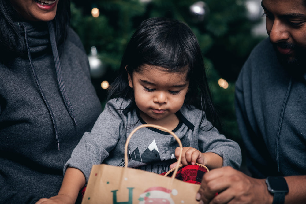 toddler opens christmas presents