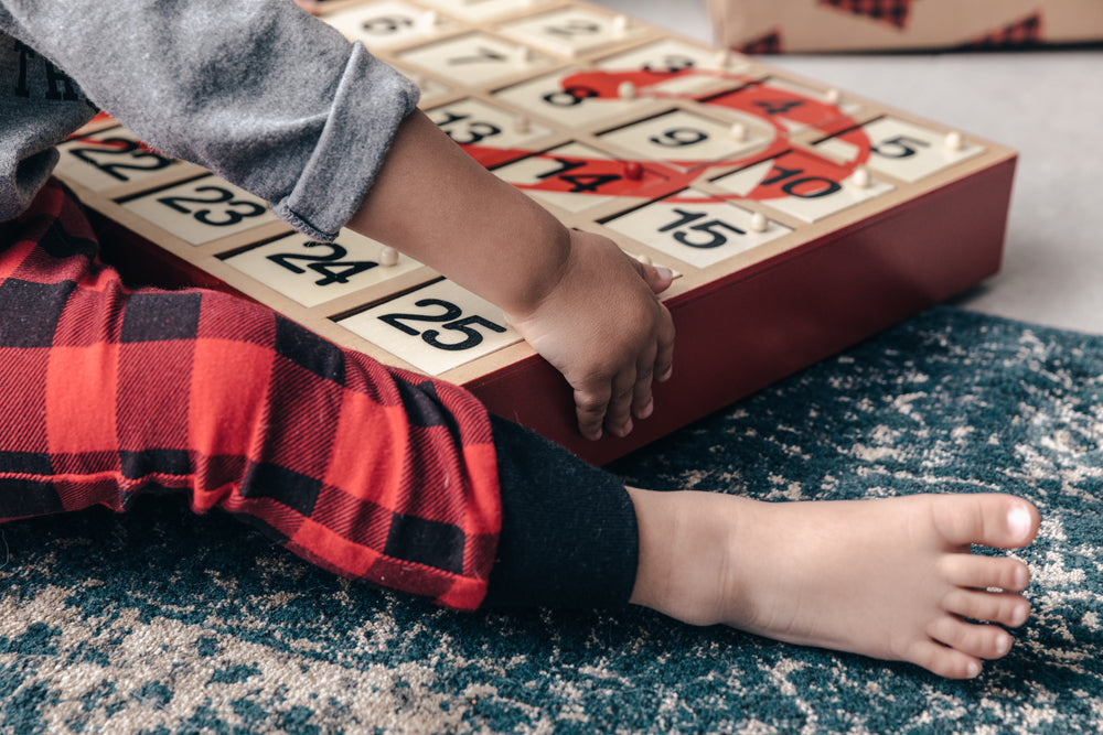 toddler plays with advent calendar