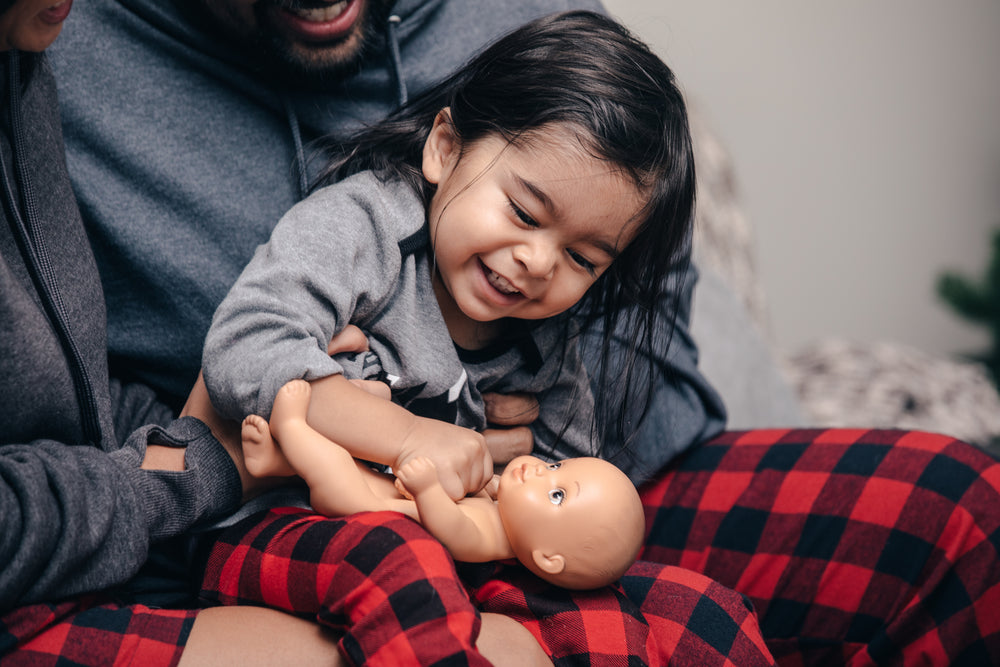 toddler plays with doll