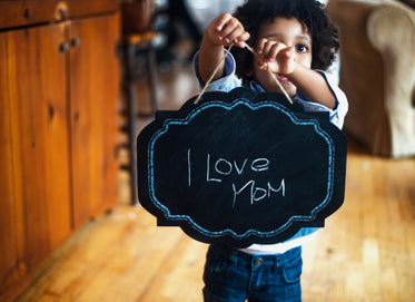 toddler with sign for mom