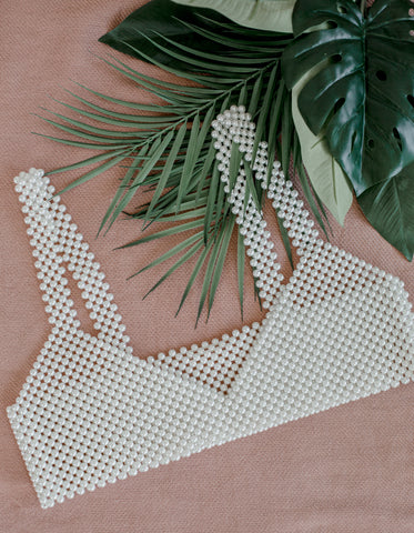 top made of pearls on a pink background