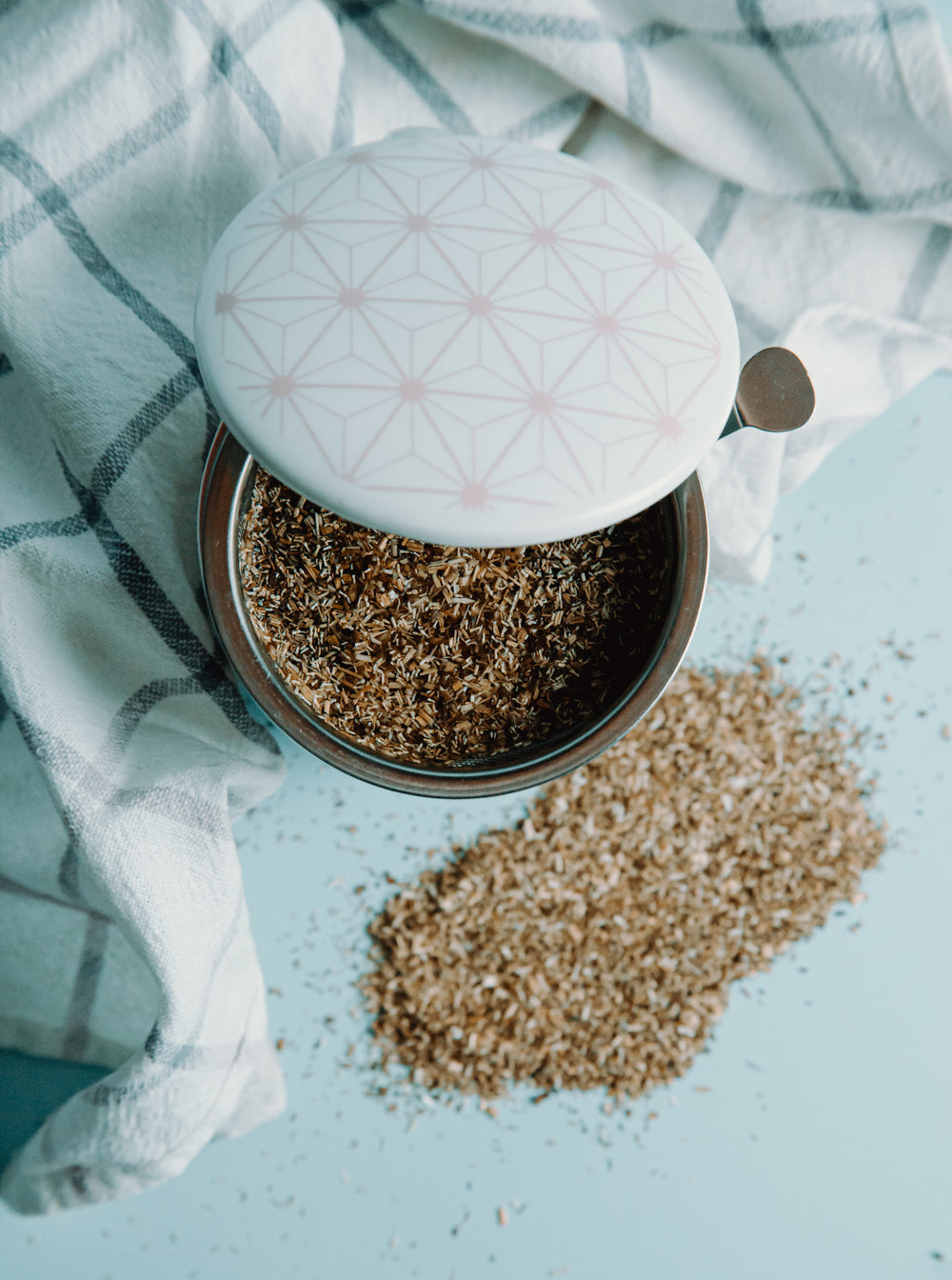 top view of a tea towel and container holding grain