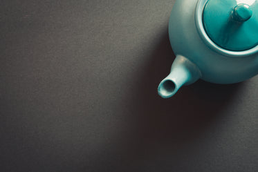 top view of a teapot against a grey background