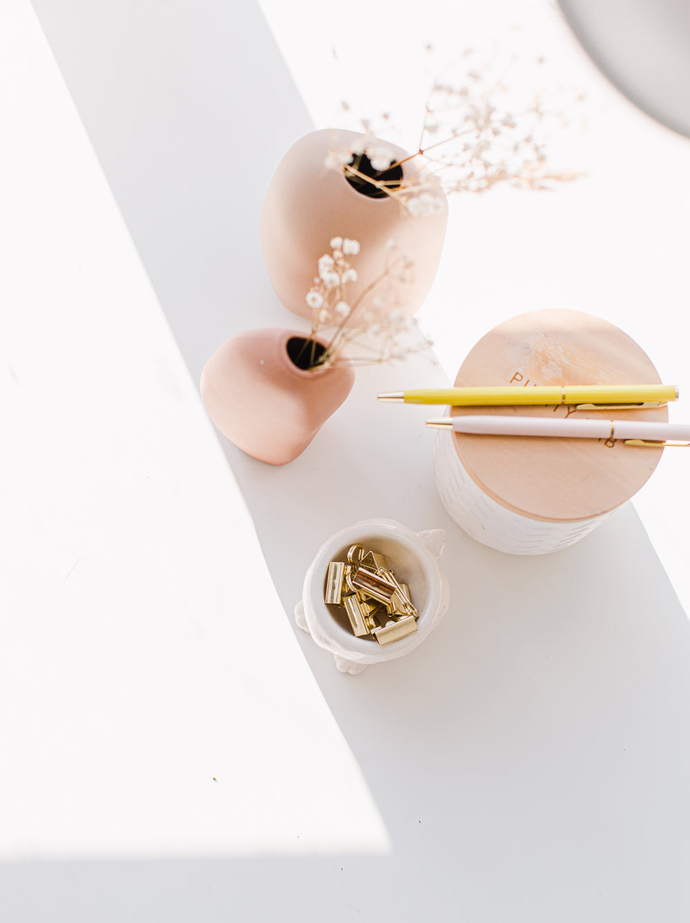 top view of dried flowers and gold paper clips