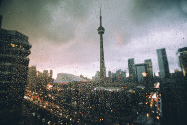 toronto skyline at night through raindrop covered window
