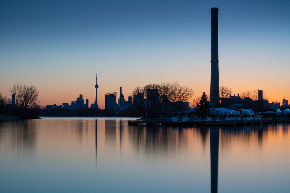 toronto skyline at sunset reflecting into waterfront