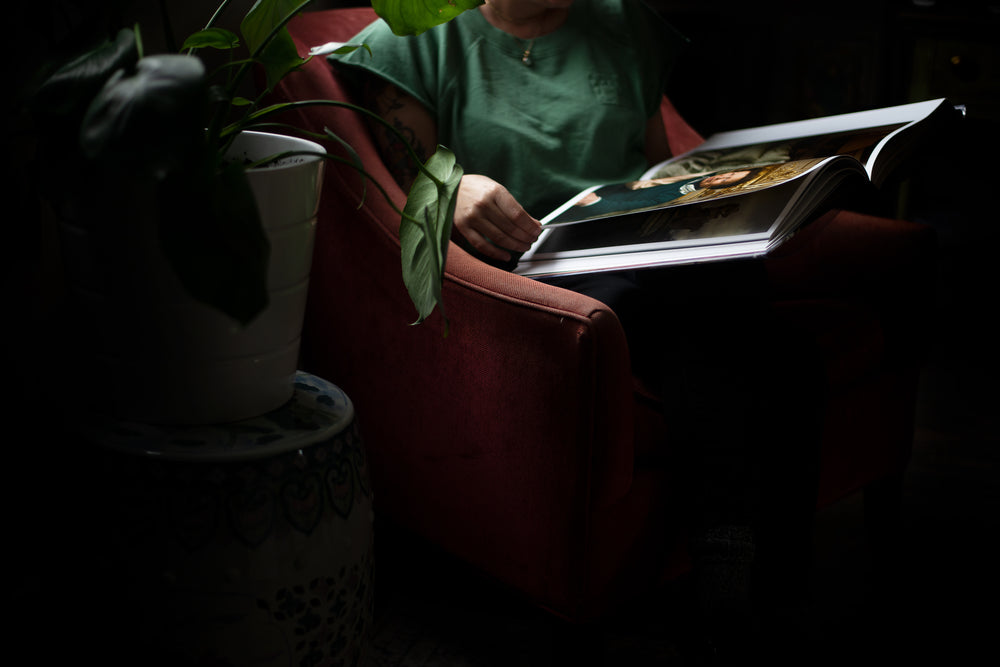 torso of a person holding a large book on their lap