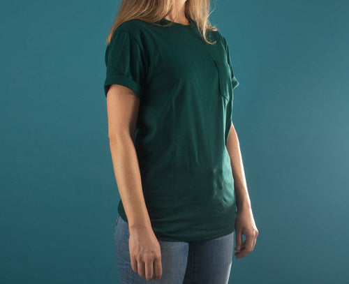 torso of a person in a green shirt against blue background