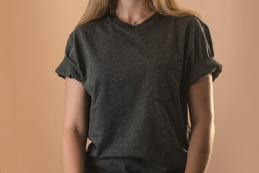 torso of a person in a plain grey shirt