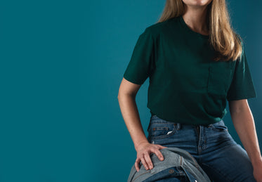 torso of a person sitting down wearing jeans and a shirt