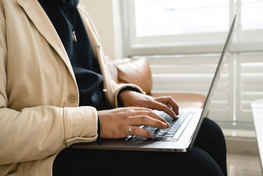 torso of a person typing in their lap