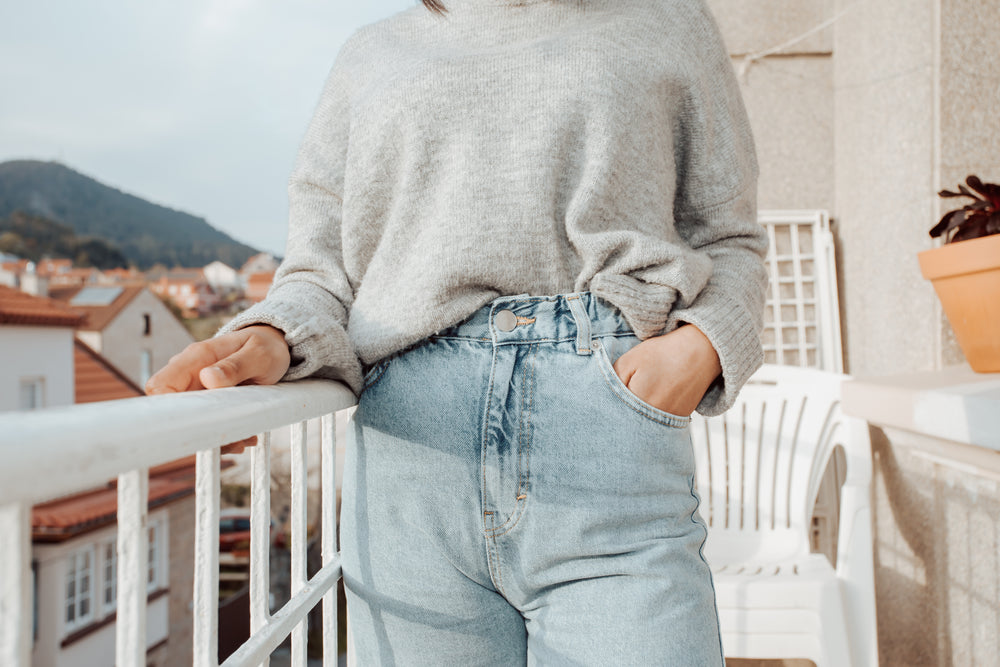 torso of person on an apartment balcony facing camera