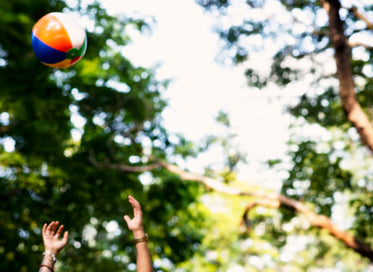 tossing beach ball at the park